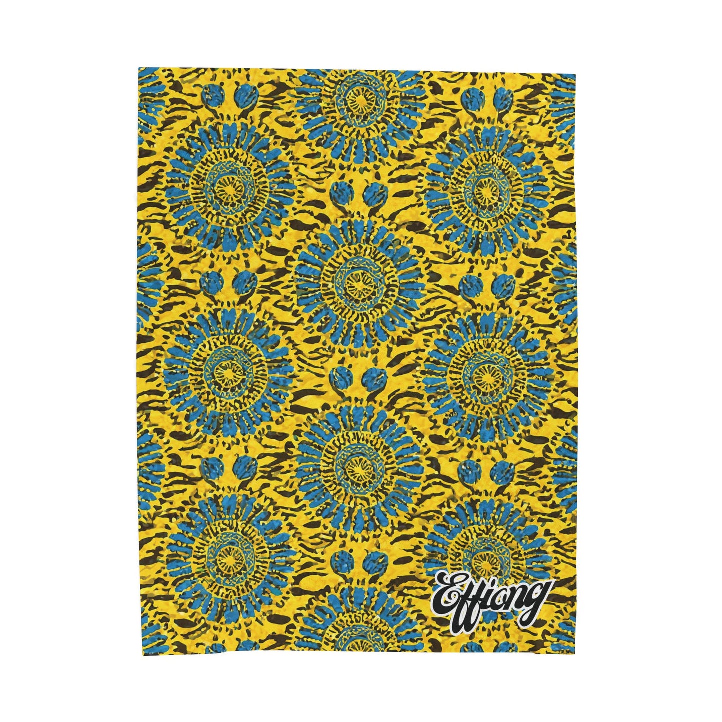 A vibrant African-inspired blanket features a repeating pattern of blue and yellow sunburst shapes with black accents on a yellow background. The word Effang is scripted in white with a black outline in the lower right corner.
