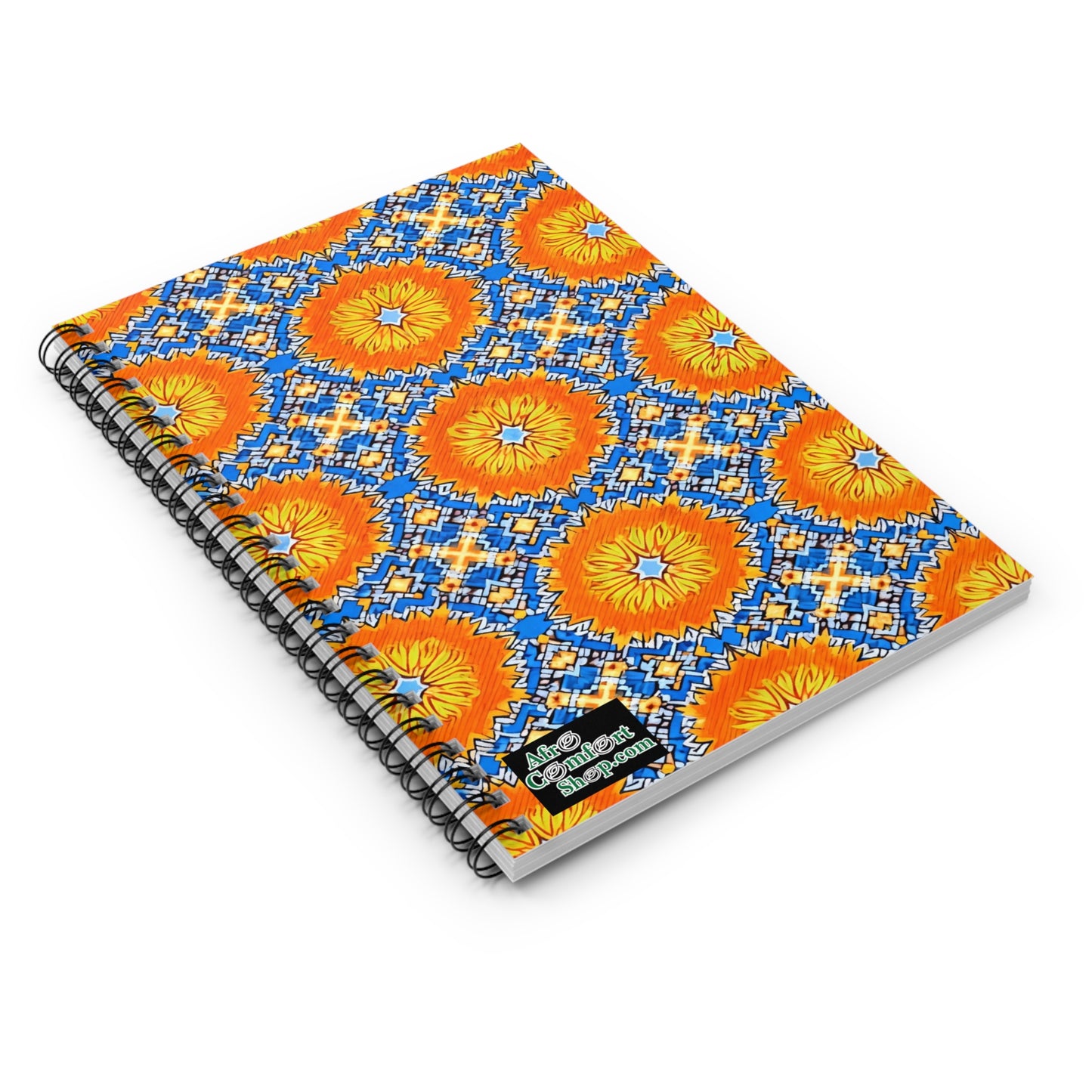 A culturally inspired notebook, this spiral journal features a vibrant orange and yellow geometric floral pattern over a blue and white background. Bold and symmetrical, it includes a small “Good Vibes Happen.” label on the lower right corner.