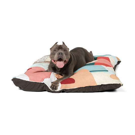 An African-Inspired dog lies comfortably on a pillow, adding a touch of vibrant culture to the cozy scene.