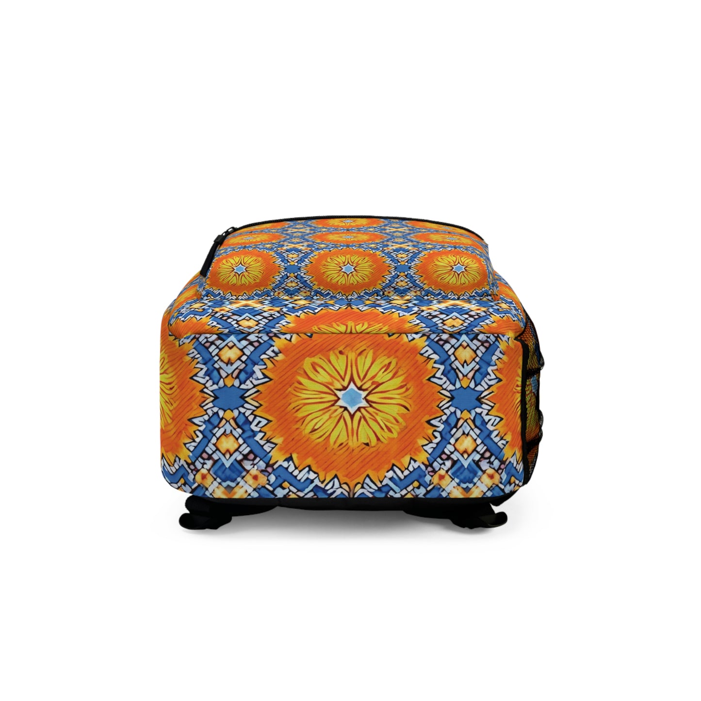 A rectangular ottoman with a vibrant, geometric pattern inspired by boho chic rucksack designs. Large orange and yellow sunburst shapes are surrounded by blue and white diamond motifs, with short black legs and a smooth, upholstered surface.
