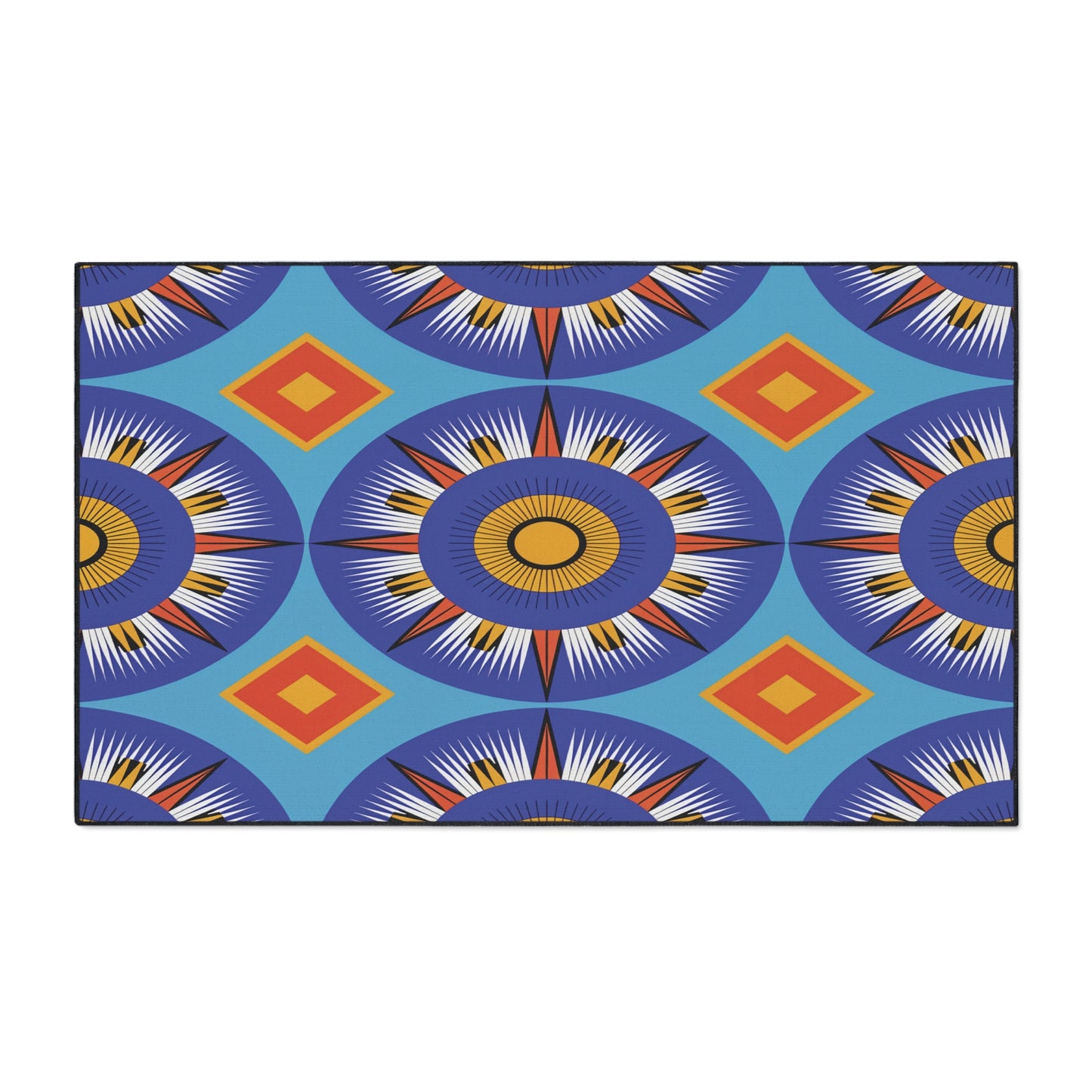 A rectangular African-inspired floor mat featuring bold geometric patterns in blue, orange, yellow, and white. Large sunburst circles alternate with orange diamonds on a bright blue background. Includes a non-slip rubber backing for safety.