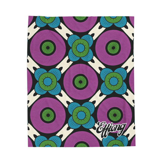 A vibrant, geometric African-inspired blanket featuring large purple circles with blue and green floral shapes on a cream background. Black diagonal lines add contrast, while Effiong appears in bold script—perfect as a personalized velveteen blanket.