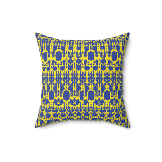 A square faux suede pillow with a bold geometric pattern in yellow and dark blue. The symmetrical motifs evoke the style of an African accent pillow, creating a visually striking contrast against the white background when viewed from the front.