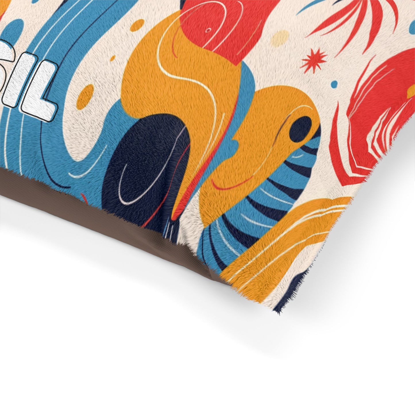 A close-up of a colorful, African-inspired abstract-patterned rug with wavy shapes in blue, yellow, red, and orange hues. The rugs edge is slightly frayed, and part of white text with black outline reading SIL appears on the left side.