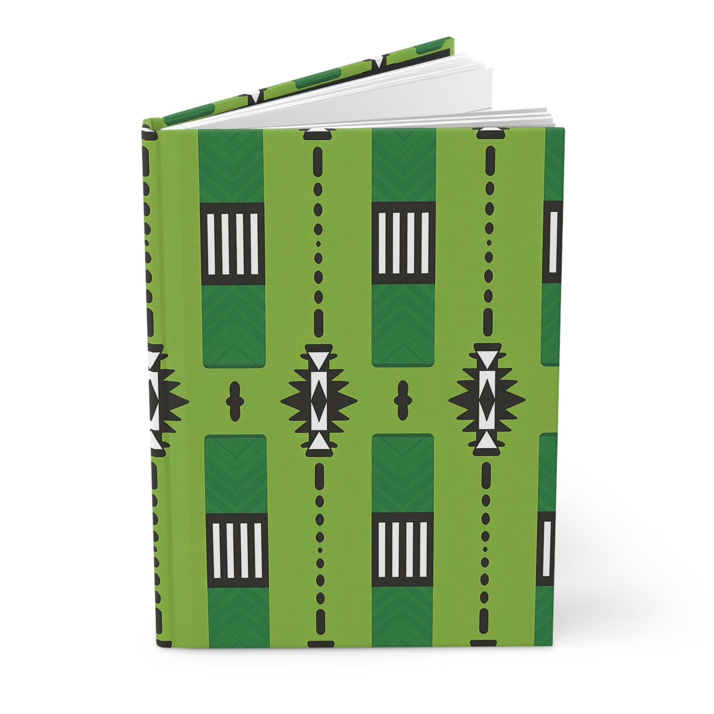 A hardcover journal with a green cover featuring a geometric black, white, and dark green pattern of rectangles, dots, and triangular shapes in vertical rows; this African-inspired journal is partially open, revealing crisp white pages.