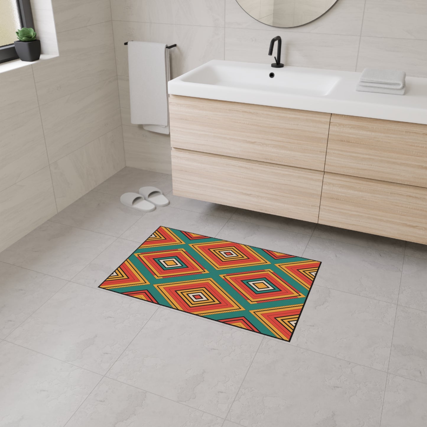 A modern bathroom with light beige tiled walls and floors, a wooden vanity with a white sink, and a round mirror. An African-inspired, non-slip geometric rug in red, yellow, teal, and orange adds a vibrant touch to the space.