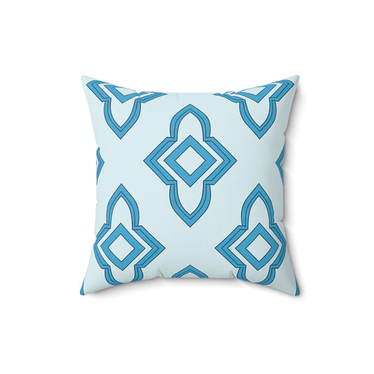 A square faux suede pillow with a light blue background, featuring a geometric diamond pattern in blue shades. The modern, symmetrical design adds a decorative touch, making this pillow appear soft, plush, and perfect as an African accent pillow.