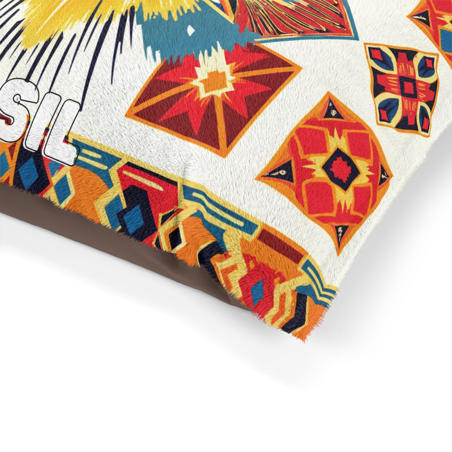A close-up of a colorful, African-inspired fabric or textile with geometric patterns in red, yellow, blue, and orange. The edge has a fringed finish. Part of the white text SIL is visible on the left, partially cropped out of the frame.