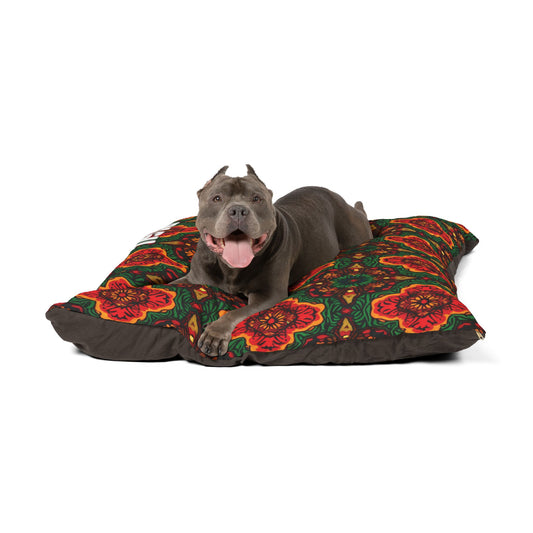 A happy gray dog with cropped ears lies on a large cushion featuring a red, orange, and green floral pattern. This personalized pet bed offers luxurious comfort as the dog pants joyfully, looking directly at the camera against a plain white background.