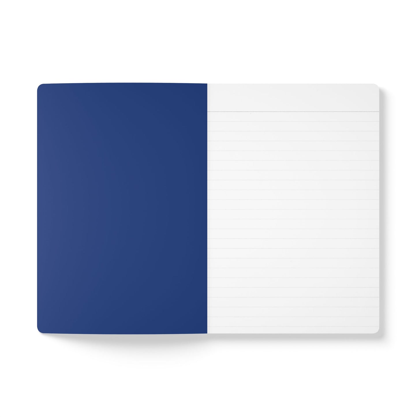 An open notebook lies flat on a white surface. The left page is solid dark blue, while the right page is white with light grey lines for writing. Its clean, minimalistic style makes it perfect for travel diary notes or creative journaling.