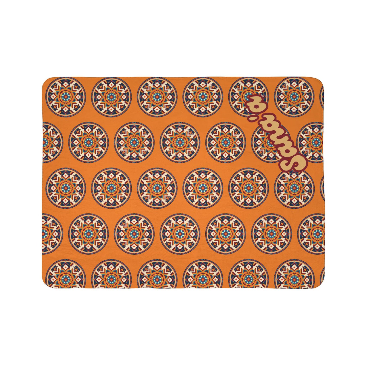 Rectangular mat with an orange background and a repeating African-inspired circular geometric pattern in black, white, blue, and red. The word sanaar in bold, beige letters is angled and overlaid across the upper right side of the mat.