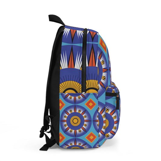 A vibrant African-inspired backpack with geometric patterns in blue, orange, yellow, black, and white. Featuring sunburst shapes and diamonds, this bag has a front pocket, black straps, and a striking side profile against a white background.