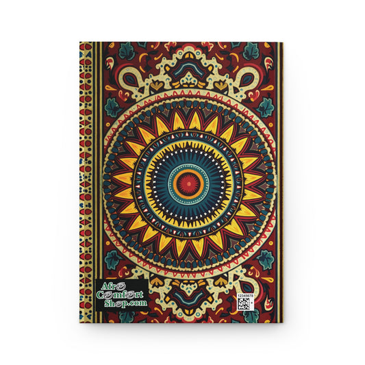 A vibrant African-inspired hardcover journal featuring a mandala design in red, yellow, blue, and green with a sunflower-like center. AfroComiArt shop.com and a QR code are in the bottom left corner.