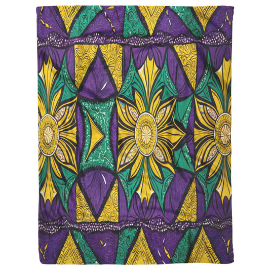 A vibrant fabric pattern featuring geometric shapes and large floral star designs in yellow, green, and purple, inspired by African fleece blankets. Flowers with radiating petals are surrounded by bold motifs for a lively look.