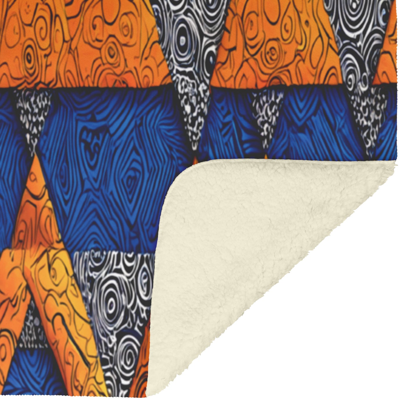 A fleece blanket is shown with its corner folded over. The front features an African-inspired geometric pattern with orange, blue, and black-and-white triangles swirling with woodgrain-like designs. The folded corner reveals a soft, off-white fleece underside.