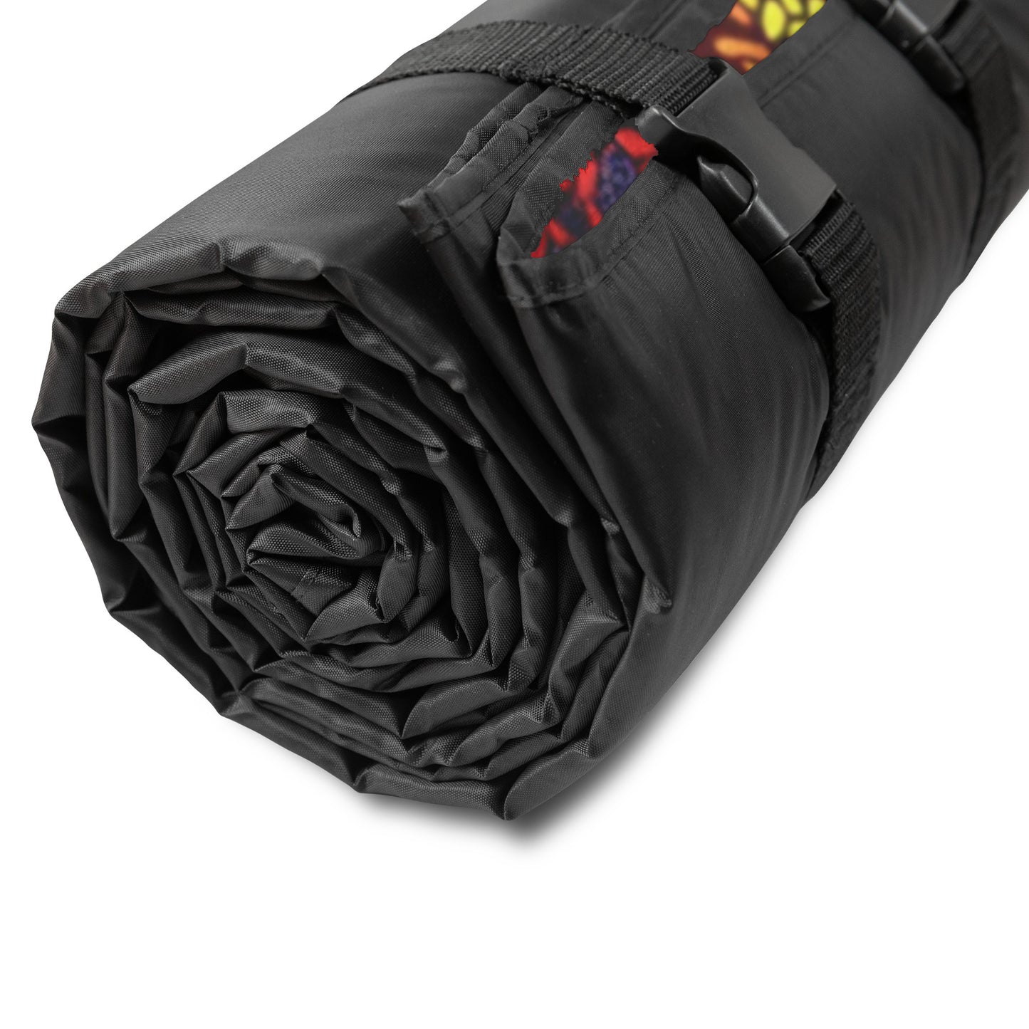 A tightly rolled black mat with adjustable straps and buckles, a hint of African-inspired patterns peeking from one end, set against a white background. The design suggests its a portable, water-resistant stadium blanket ideal for outdoor or fitness use.