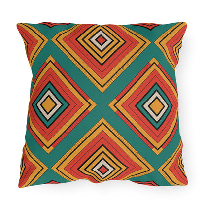 A square outdoor pillow featuring a bold geometric pattern of concentric diamonds in red, yellow, black, and white on a teal background. Crafted from weatherproof materials, this vibrant decorative piece is perfect for modern outdoor spaces.
