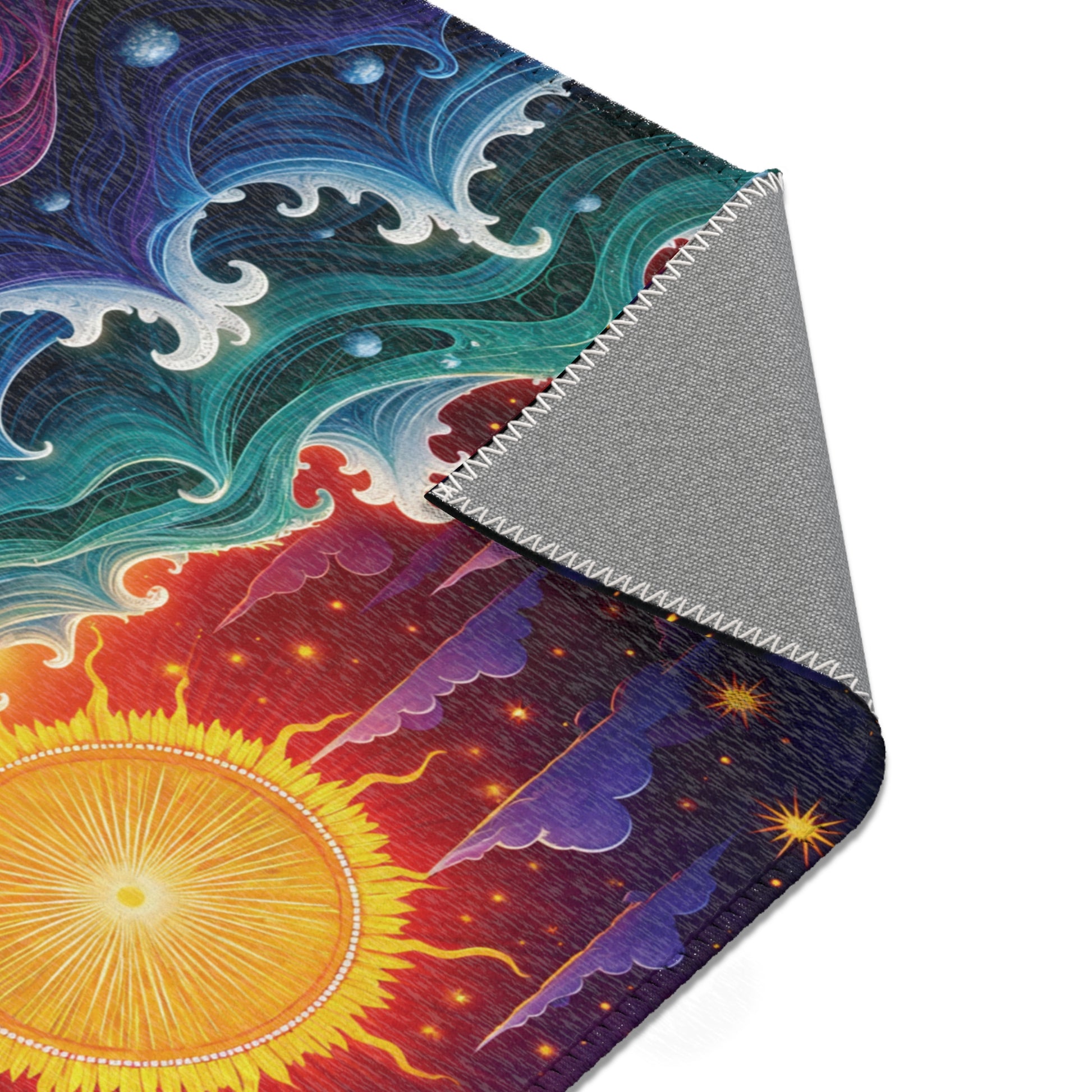 A close-up of a colorful fabric with an abstract cosmic design, featuring the sun, radiant yellow rays, and starry sky—perfect for stylish home decor. One corner is folded to reveal a plain gray back and neat zigzag stitching along the edge.