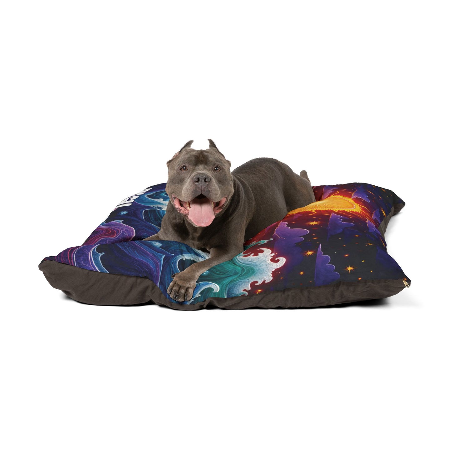 A happy gray pit bull with cropped ears and a pink tongue out lies on a colorful dog bed. The vibrant bed, resembling a cosmic landscape, boasts durable construction for luxurious comfort. The background is plain white.
