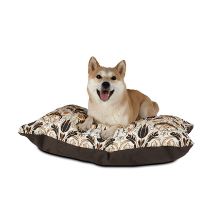 A tan Shiba Inu dog with a happy expression lies on a large, African-inspired cushion featuring a brown and beige floral pattern with a dark brown border, set against a plain white background.
