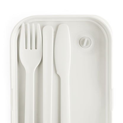 A white plastic fork, knife, and spoon are neatly arranged side by side inside a BPA-free lunchbox with rounded corners. The container features a circular vent with a tab in the top right corner, offering a minimal and modern design.