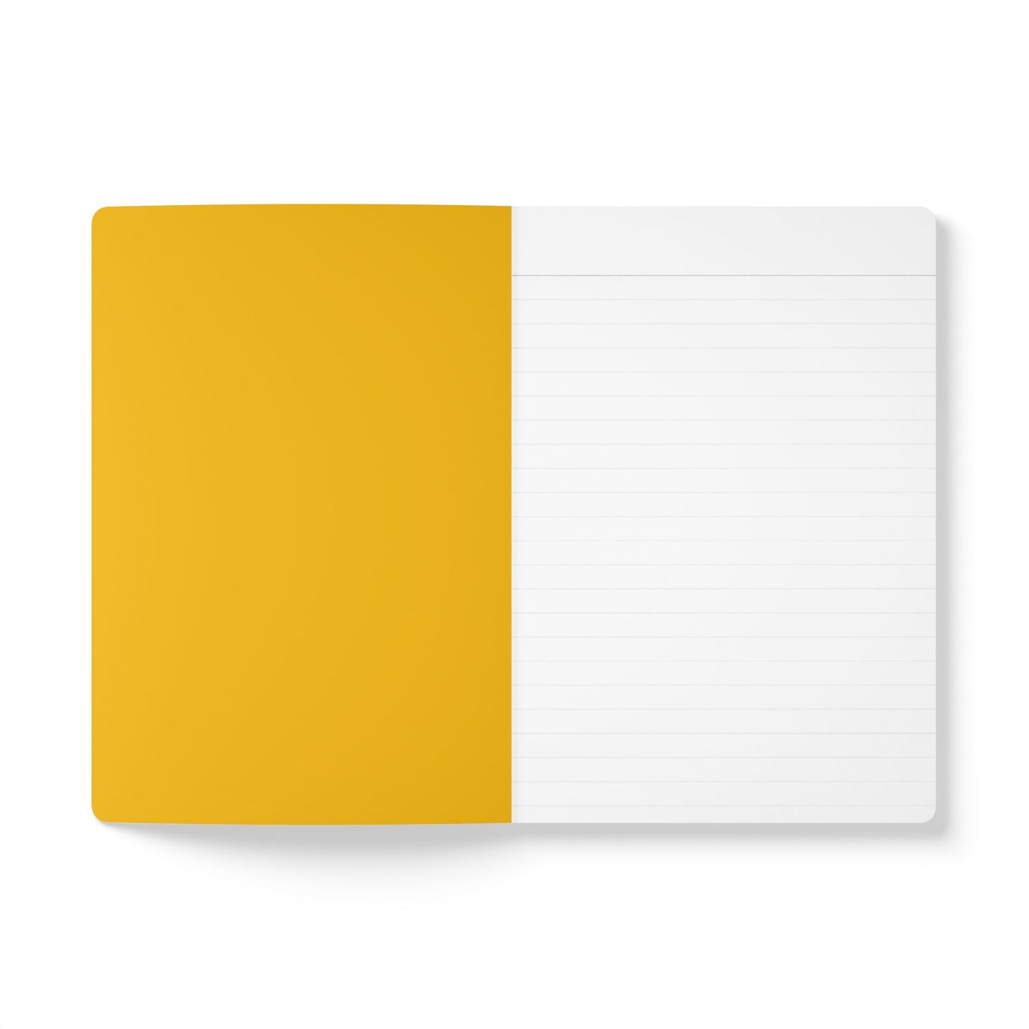 An open creative journal lies flat on a white surface. The left page is solid mustard yellow, while the right page is white with thin grey lines—perfect for daily journaling. The notebook cover is not visible.