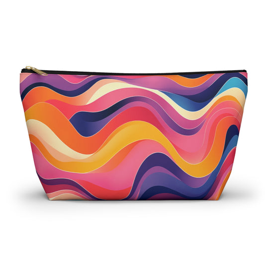 A T-bottom pouch featuring a colorful, wavy abstract pattern in shades of pink, orange, yellow, purple, and blue. Inspired by African-inspired patterns, this vibrant cosmetic travel bag has a gold zipper and soft curves on a plain white background.