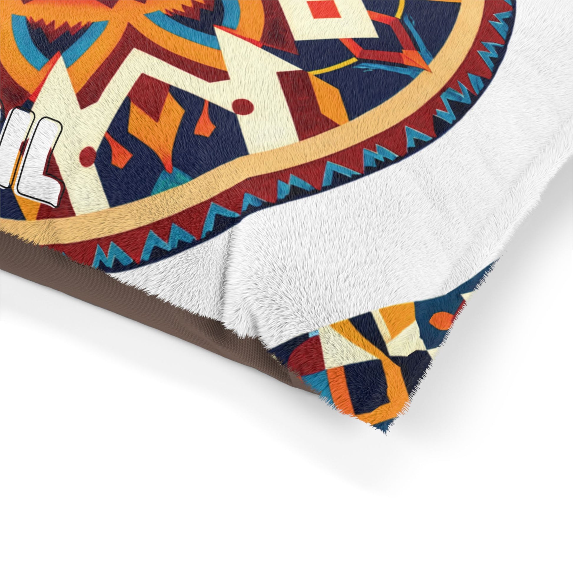 Close-up of a soft blanket featuring a colorful geometric pattern in orange, blue, yellow, and white with black outlines. The tribal or Southwestern design and white, fluffy lining offer luxurious comfort along with durable construction.