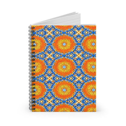 A vibrant notebook with a cover featuring a geometric pattern of orange and yellow circles surrounded by blue and white diamond designs. This African-inspired spiral notebook stands upright, revealing a few lined pages at the top.