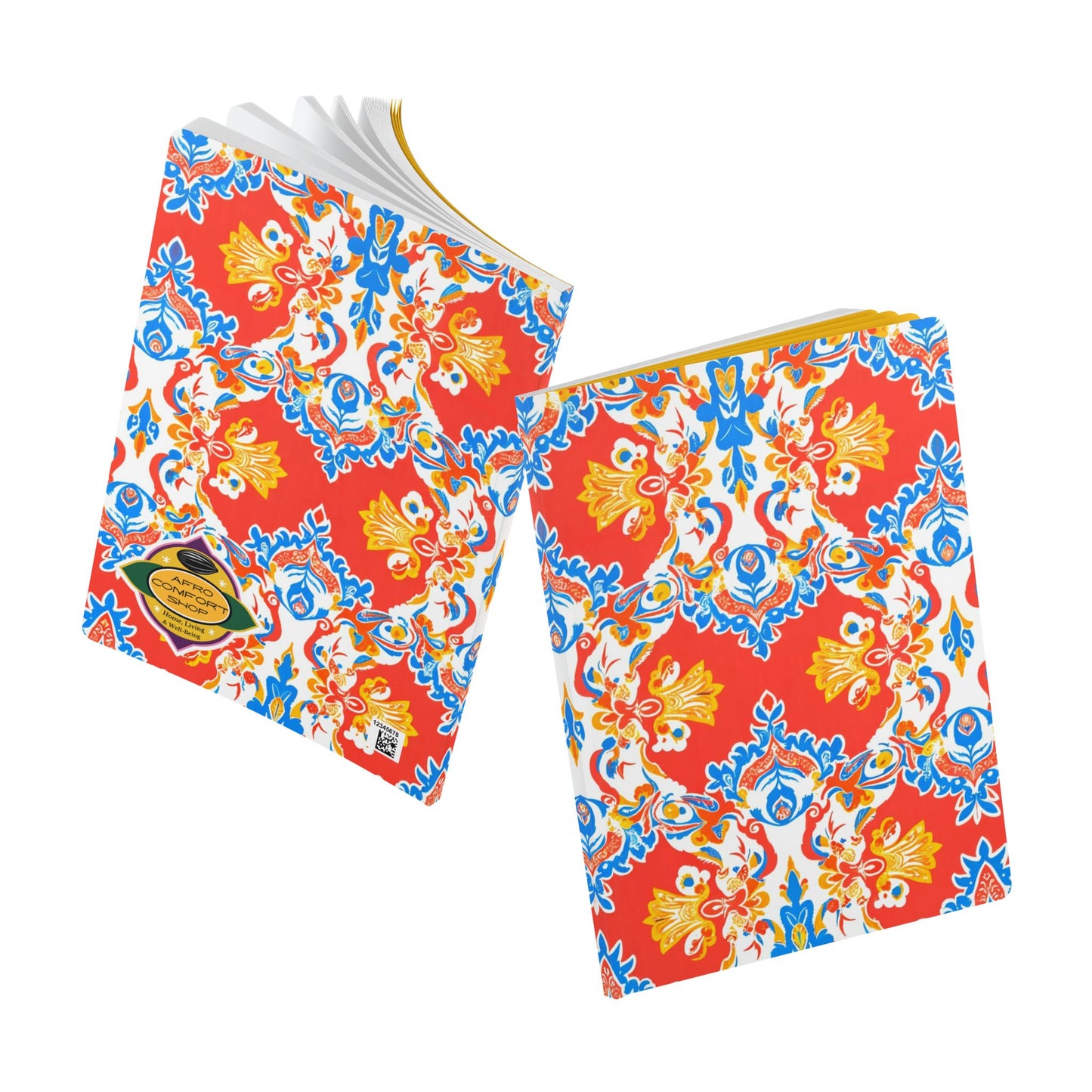 Two notebooks with vibrant, ornate covers inspired by African designs are perfect for creative journaling. Each travel diary features a red background and symmetrical yellow, blue, and white floral patterns, with a gold label on the front of one notebook.
