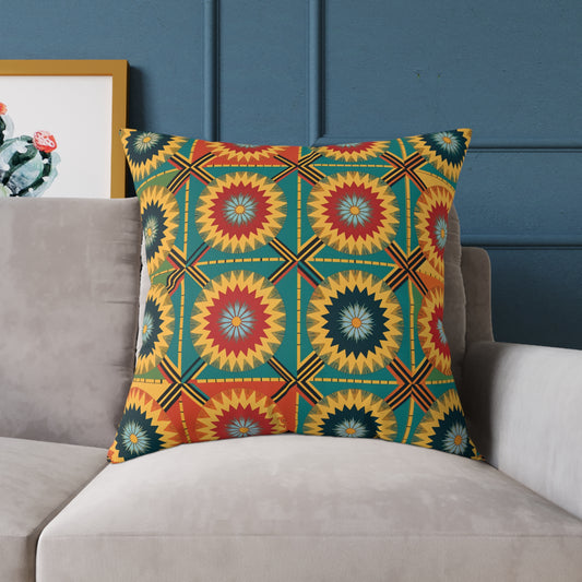 A vibrant throw pillow with a bold geometric pattern in red, yellow, teal, and blue sits on a light gray couch. The blue wall and a framed cactus print add to the colorful home decor for a lively and inviting space.