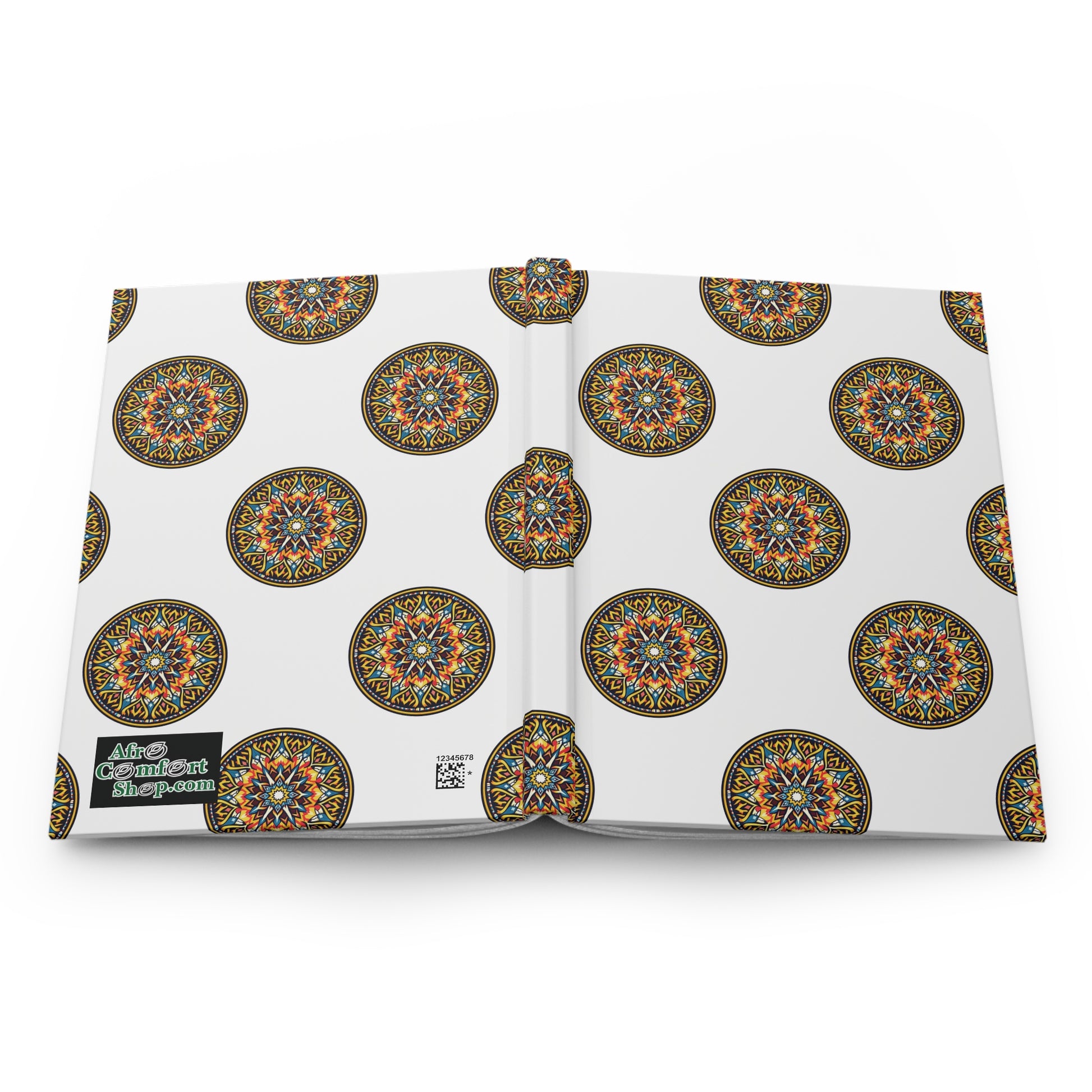 An open hardcover journal with a white cover featuring colorful, intricate circular mandala designs inspired by African art. A black label on the back reads “More Content Ahead.” The lined pages are displayed against a white background.