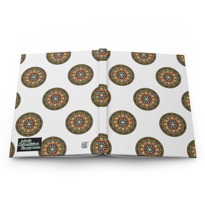 An open hardcover journal with a white cover featuring colorful, intricate circular mandala designs inspired by African art. A black label on the back reads “More Content Ahead.” The lined pages are displayed against a white background.