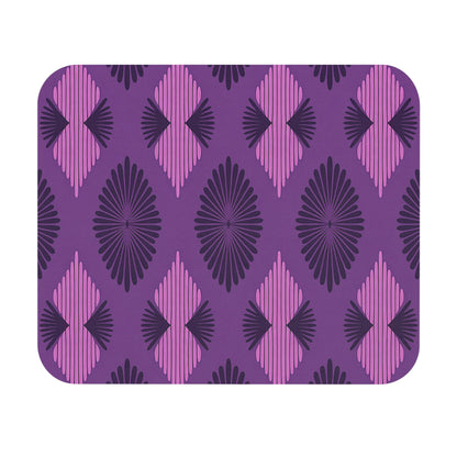 A rectangular mat with rounded corners features a repeating geometric pattern of purple, dark purple, and pink diamond shapes. This African-inspired mouse pad has radiating lines for a bold retro look and a non-slip rubber base for stability.
