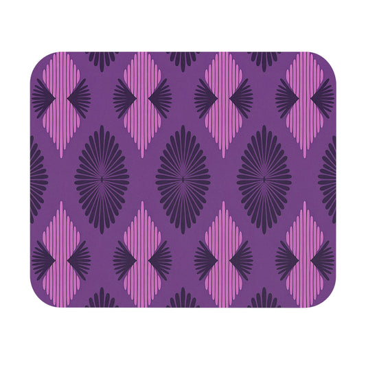A rectangular mat with rounded corners features a repeating geometric pattern of purple, dark purple, and pink diamond shapes. This African-inspired mouse pad has radiating lines for a bold retro look and a non-slip rubber base for stability.
