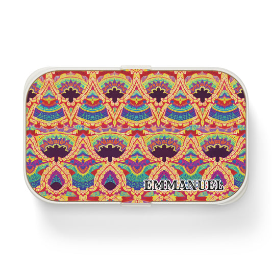 A small rectangular African-inspired bento lunch box with a colorful, intricate geometric and floral pattern in red, yellow, blue, and green. The name EMMANNUEL is printed in bold white and black letters in the lower right corner.