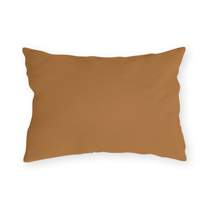 A rectangular, light brown outdoor pillow with a smooth, solid cover is shown against a plain white background. The pillow’s edges are slightly wrinkled, and its surface appears soft and plush.