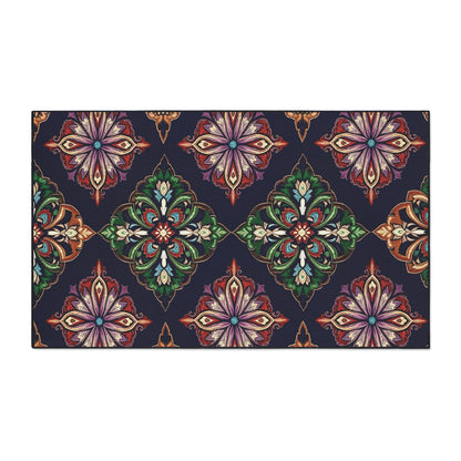 A rectangular rug with a dark navy background displays a repeating ornate pattern of stylized, symmetrical floral motifs in green, red, orange, and purple hues, arranged diagonally—featuring African-inspired aesthetics for unique flair.