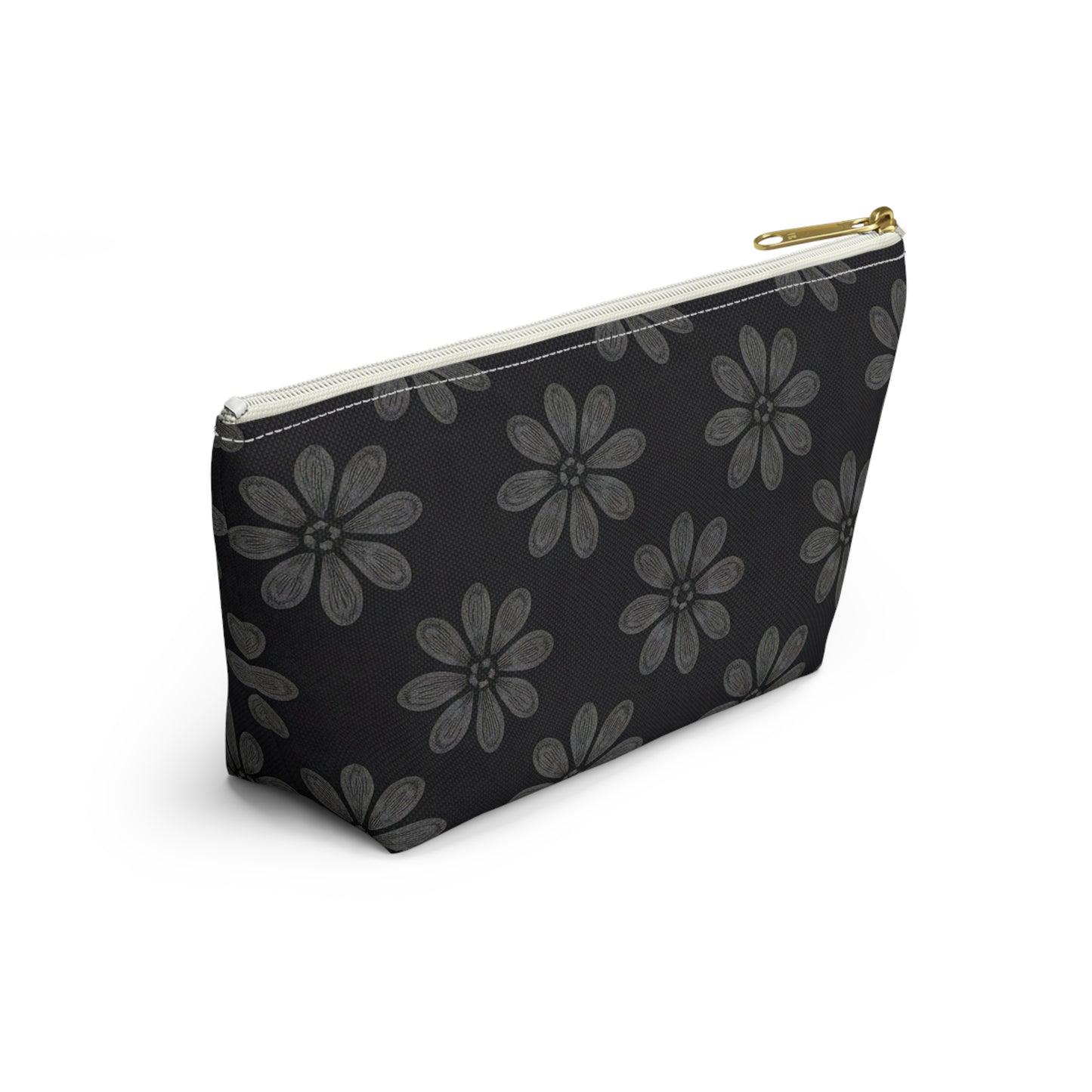 A black T-bottom pouch with a gold zipper pull, featuring a repeating pattern of large, stylized gray flowers reminiscent of African-inspired patterns. The cosmetic travel bag is positioned at an angle on a white background.