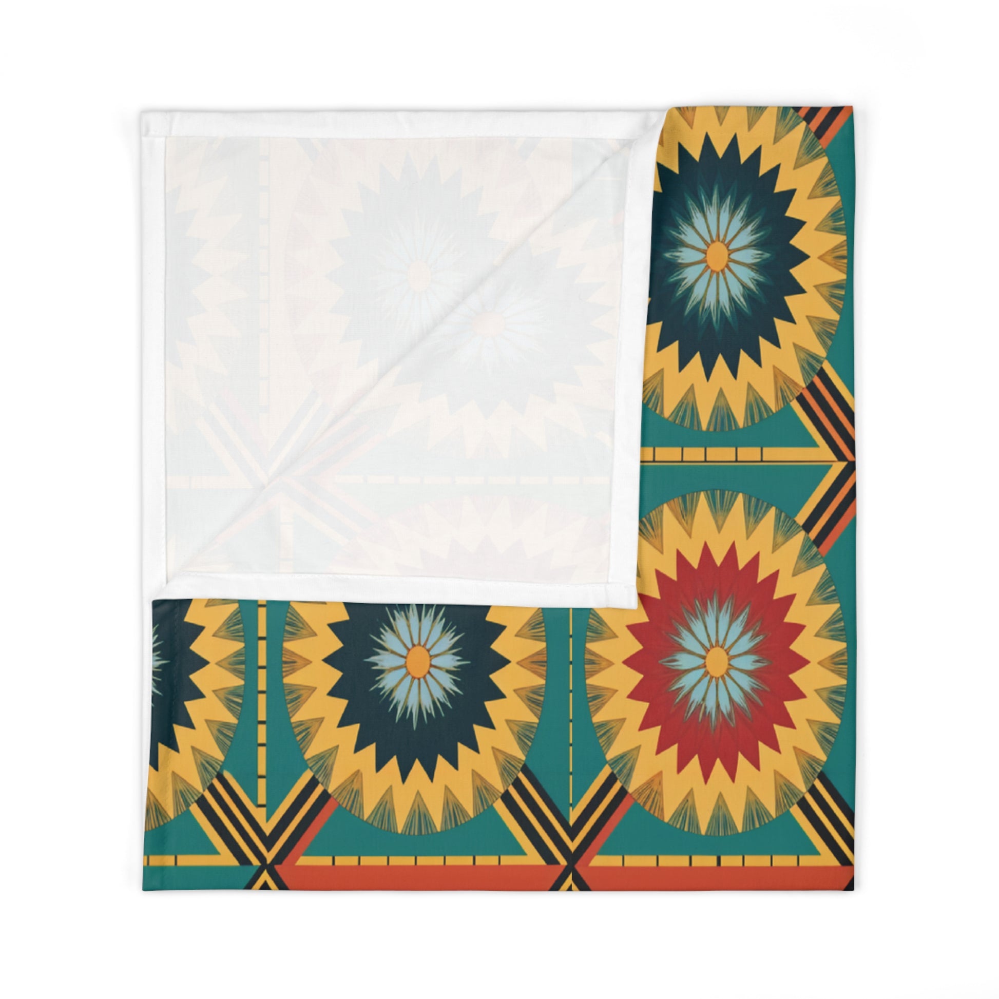 A folded fabric square featuring a vibrant geometric pattern with radiating starbursts in yellow, red, blue, and green—perfect for African-inspired decor. The upper portion shows the plain white reverse side, partially covering the patterned corner.