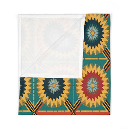 A folded fabric square featuring a vibrant geometric pattern with radiating starbursts in yellow, red, blue, and green—perfect for African-inspired decor. The upper portion shows the plain white reverse side, partially covering the patterned corner.
