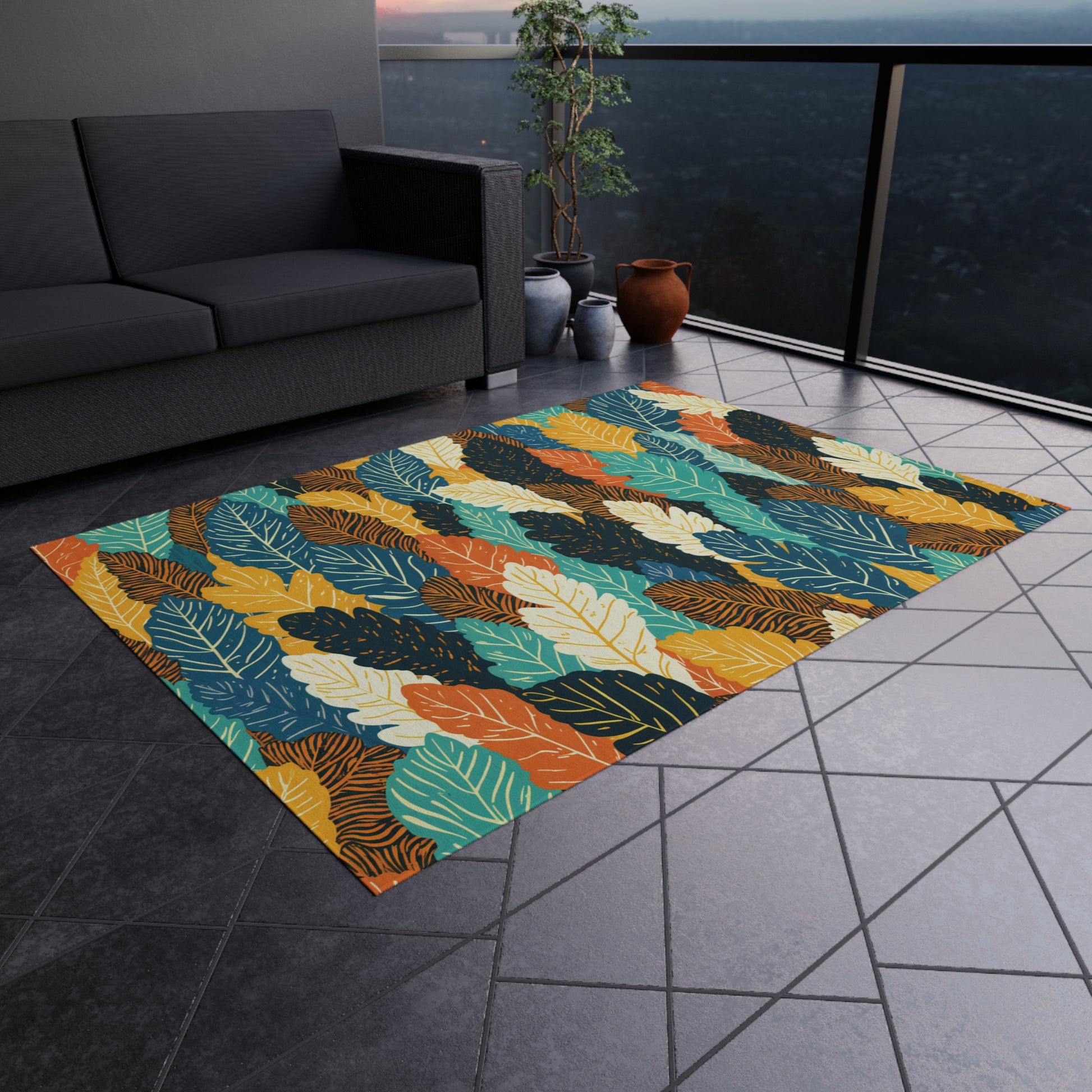 A colorful, African-inspired rug with a tropical leaf pattern in teal, orange, yellow, and green is laid on a gray tiled floor. Nearby are a dark sofa, potted plants, and clay vases, with a glass railing offering an outdoor city view.