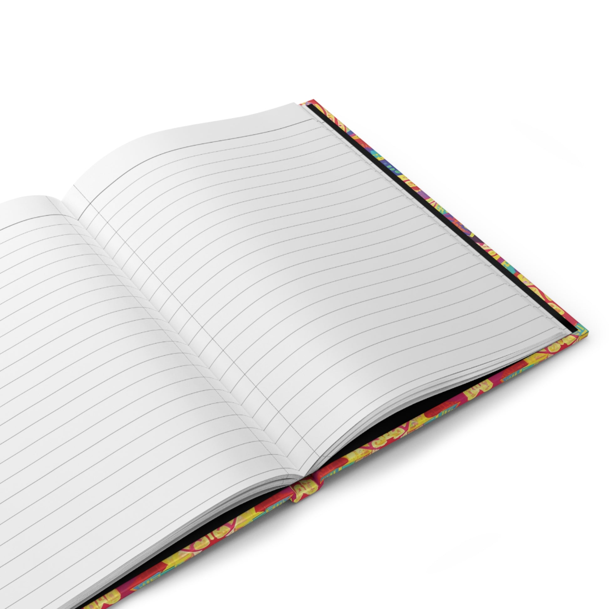 An open hardcover journal with wide-ruled, lined white pages. The colorful cover showcases a playful, African-inspired pattern along the edge. Resting on a white surface, the journal is viewed from a high angle.