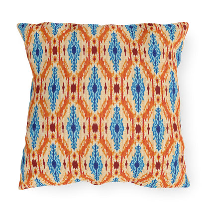 Square outdoor pillow with a textured fabric featuring a geometric zigzag pattern in orange, with blue and maroon decorative elements on a cream background. Water-resistant for durability, the design has a bold and colorful appearance.