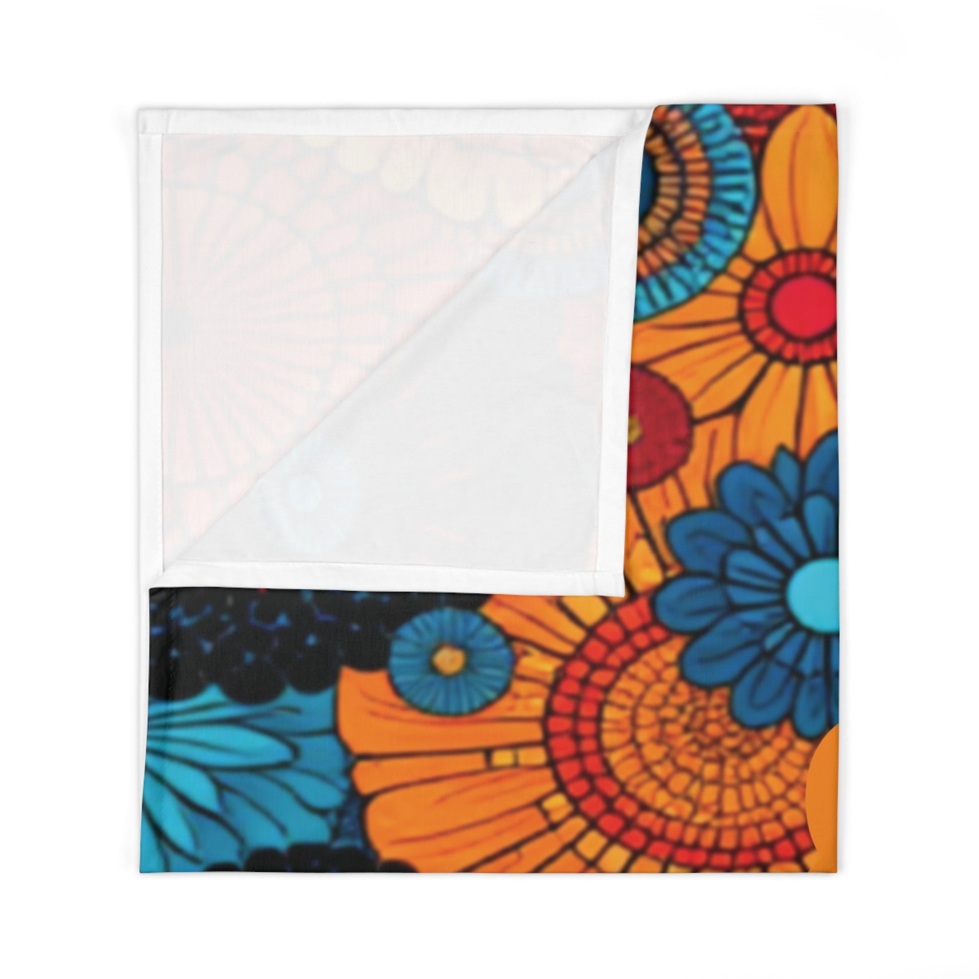A bold, colorful floral pattern adorns this custom swaddle blanket, featuring large orange, red, blue, and black flowers. Folded to reveal a white underside, the vibrant design adds a striking accent reminiscent of African-inspired decor.
