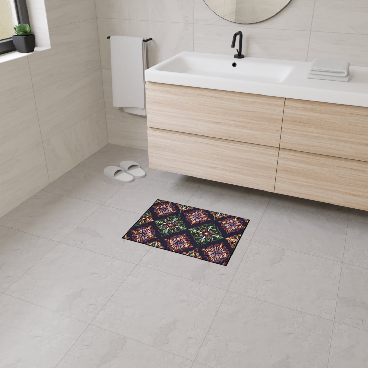 A modern bathroom with light beige tiles, a wooden vanity, and a round mirror features a small rectangular mat with African-inspired aesthetics and a colorful, symmetrical floral pattern for a vibrant touch.