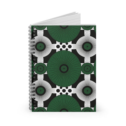 A spiral-bound African-inspired notebook with a bold geometric cover. Large green circles and starburst shapes alternate with black-and-white accents, creating a culturally inspired design against a striking polka-dotted background.