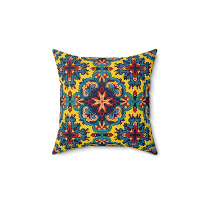 Square decorative faux suede pillow with a symmetrical, ornate pattern in blue, red, green, and orange on a bright yellow background. This African accent pillow features floral and mandala-like shapes radiating from the center for a vibrant look.