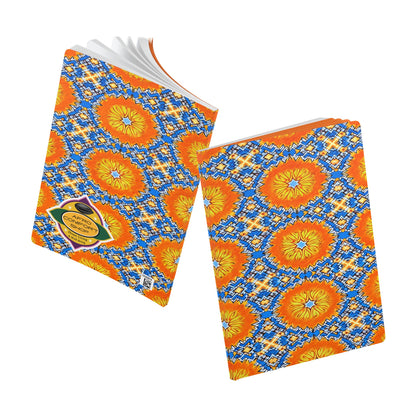Two notebooks with vibrant, geometric covers inspired by African patterns in orange, yellow, and blue. Ideal as a creative journal, one is open to reveal lined pages while the other is closed, spotlighting the colorful design and a small front label.