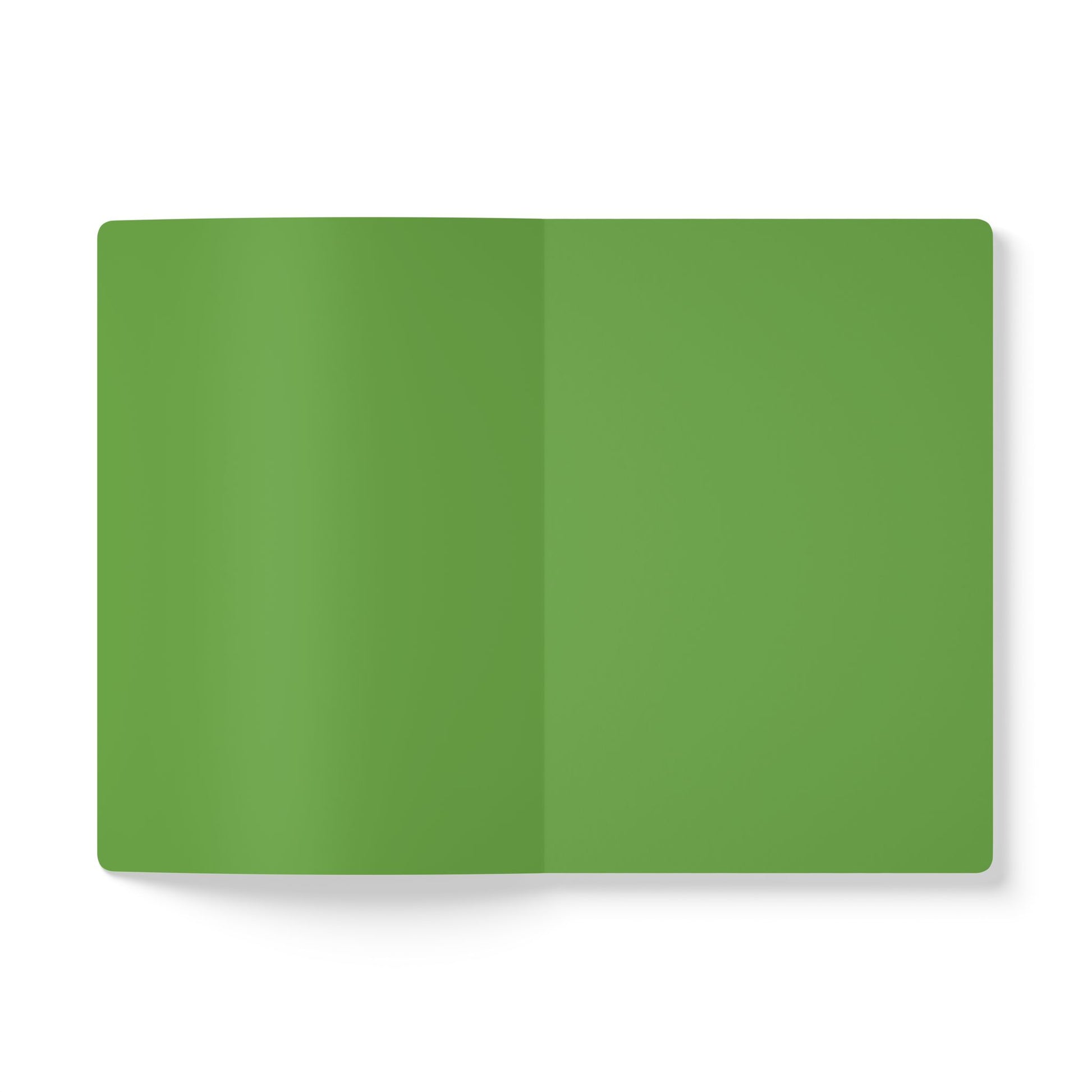 A top-down view of an open African-inspired journal or notebook with blank, solid green pages. The background is white, and there are no visible text, images, or markings. The shadows suggest a slight curve at the book’s spine.